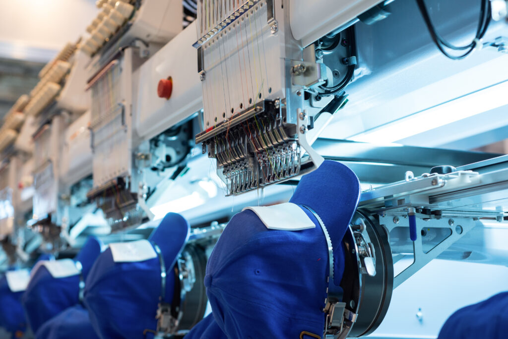 Embroidery machine being used to add a custom design to clothing garment.