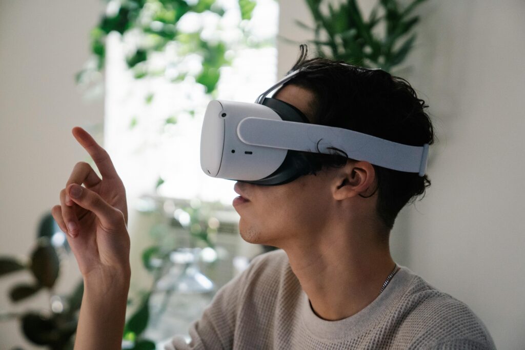 A man trying on clothes virtually using an AI-powered metaverse headset inside his home.