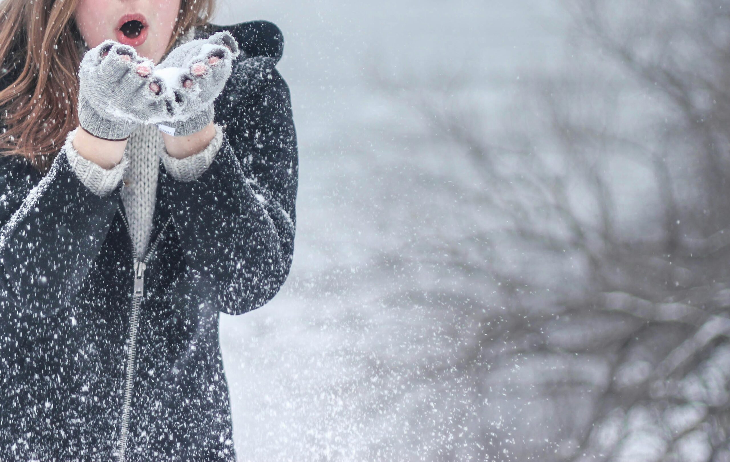 Women in warm winter layered clothing in a snow environment.